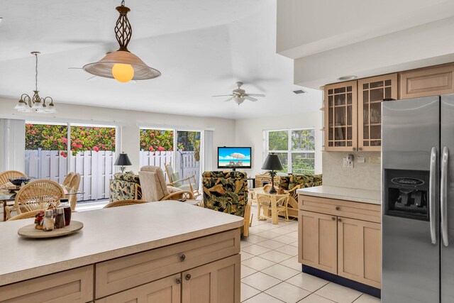 120 9th St, Key Colony, FL 33051 - kitchen with stainless steel fridge with ice dispenser, light countertops, light tile patterned floors, and glass insert cabinets