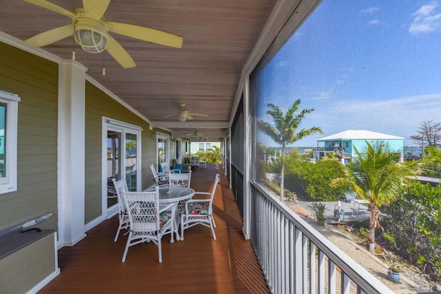 sunroom with lofted ceiling, wooden ceiling, and ceiling fan