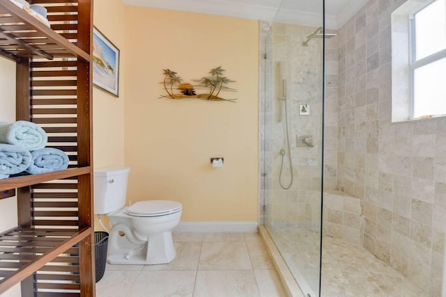 bathroom with crown molding, tiled shower, and toilet