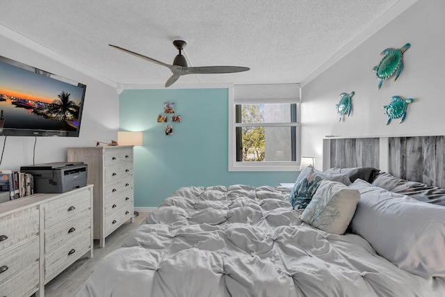 bedroom featuring crown molding, a textured ceiling, and ceiling fan