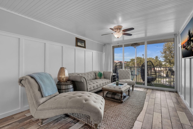 sunroom / solarium featuring ceiling fan