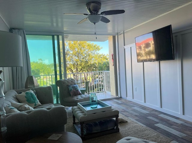 sunroom / solarium featuring a healthy amount of sunlight and ceiling fan