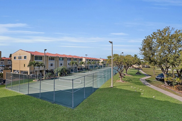 view of tennis court with a lawn