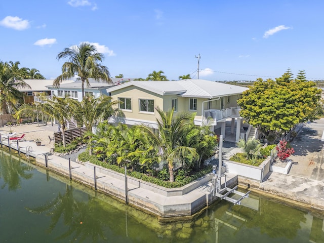 365 Pirates Rd, Little Torch, FL 33042 - back of house with a water view, a balcony, stairway, and metal roof