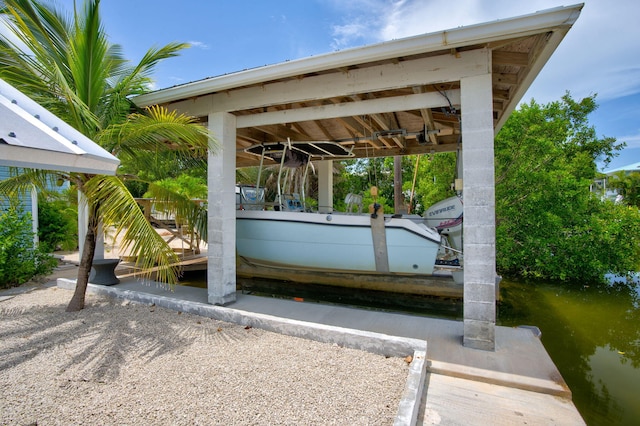 22841 Buccaneer Ln, Cudjoe, FL 33042 - view of parking with a dock, boat lift, and a water view