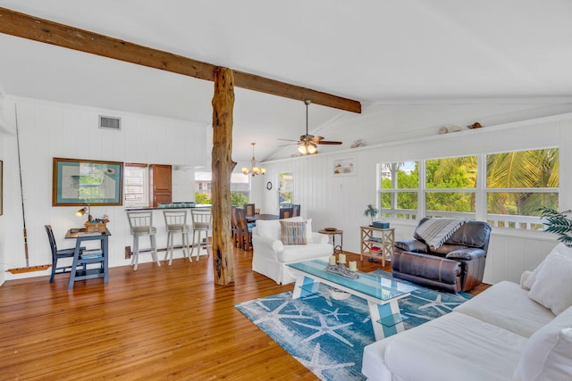 22841 Buccaneer Ln, Cudjoe, FL 33042 - living room featuring wood finished floors, a chandelier, a ceiling fan, and wooden walls