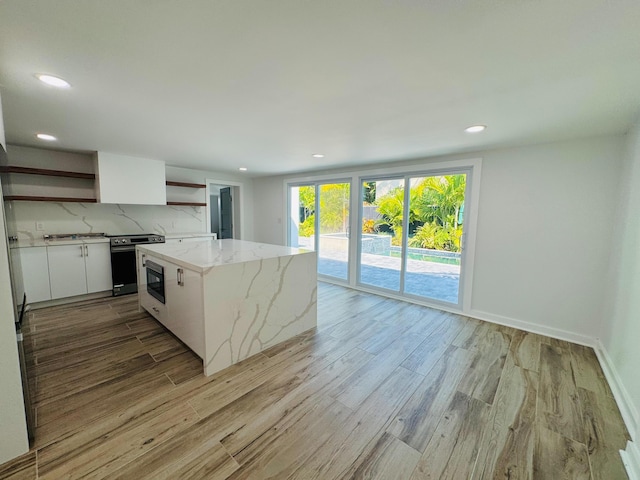 1708 Duncan St, Key West, FL 33040 - kitchen featuring open shelves, recessed lighting, light wood finished floors, white cabinetry, and built in microwave