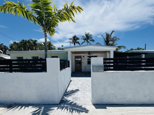 1708 Duncan St, Key West, FL 33040 - view of front of house with a fenced front yard, stucco siding, and a gate