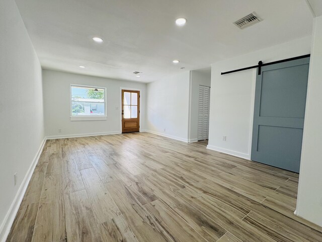 1708 Duncan St, Key West, FL 33040 - spare room featuring a barn door, light wood finished floors, and recessed lighting