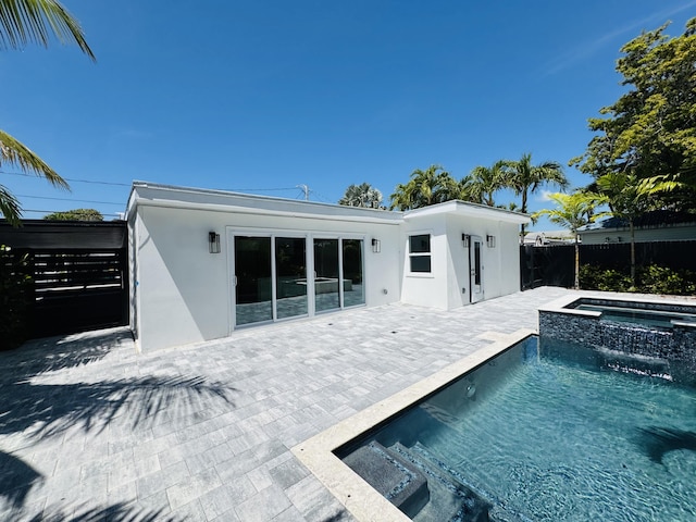 1708 Duncan St, Key West, FL 33040 - rear view of property featuring stucco siding, a patio, and a pool with connected hot tub