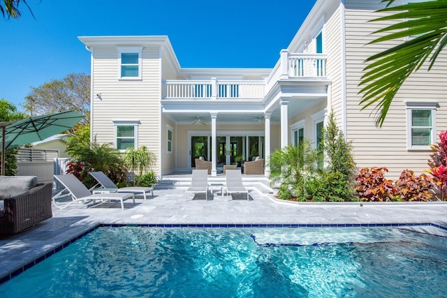 back of house featuring a patio area, a balcony, and ceiling fan