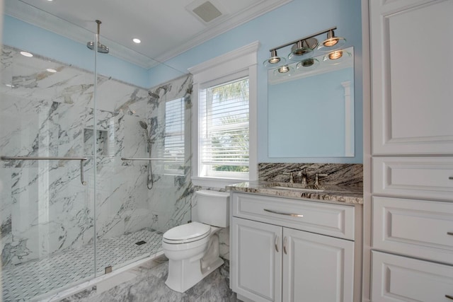 bathroom featuring crown molding, vanity, toilet, and a shower with shower door