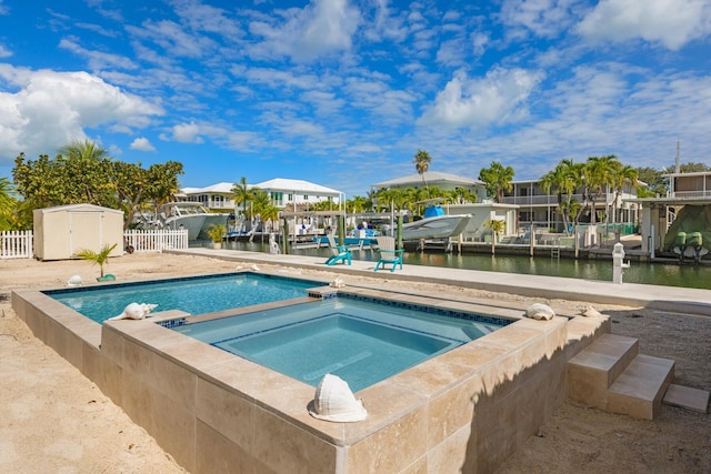240 S Coconut Palm Blvd, Tavernier, FL 33070 - swimming pool with an in-ground hot tub, a storage unit, and a water view