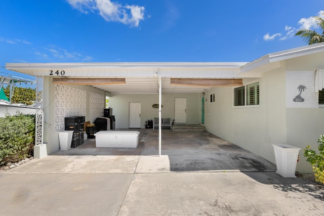 240 S Coconut Palm Blvd, Tavernier, FL 33070 - view of patio featuring an attached carport and concrete driveway