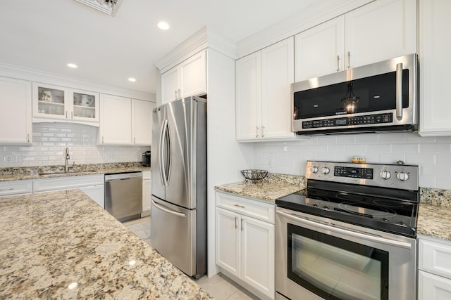 240 S Coconut Palm Blvd, Tavernier, FL 33070 - kitchen featuring appliances with stainless steel finishes, white cabinetry, tasteful backsplash, light stone counters, and recessed lighting