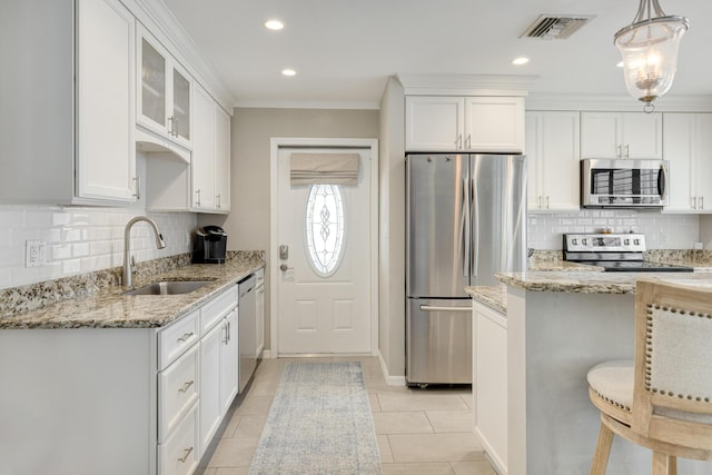 240 S Coconut Palm Blvd, Tavernier, FL 33070 - kitchen featuring appliances with stainless steel finishes, white cabinetry, tasteful backsplash, light stone countertops, and recessed lighting