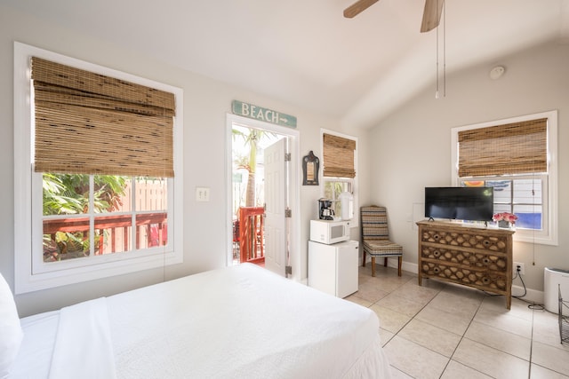 718 Chapman Ln, Key West, FL 33040 - bedroom with multiple windows, vaulted ceiling, light tile patterned floors, and a ceiling fan