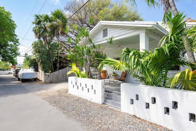 718 Chapman Ln, Key West, FL 33040 - view of side of home featuring a fenced front yard and a gate
