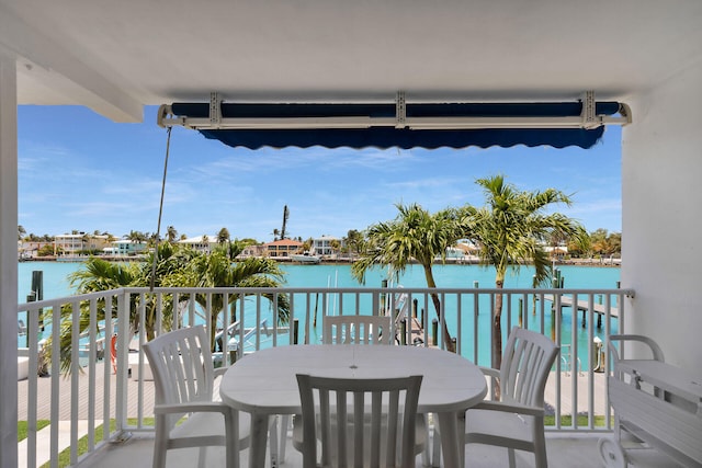 95 Coco Plum Dr Unit 2D, Marathon, FL 33050 - balcony featuring a water view and outdoor dining area