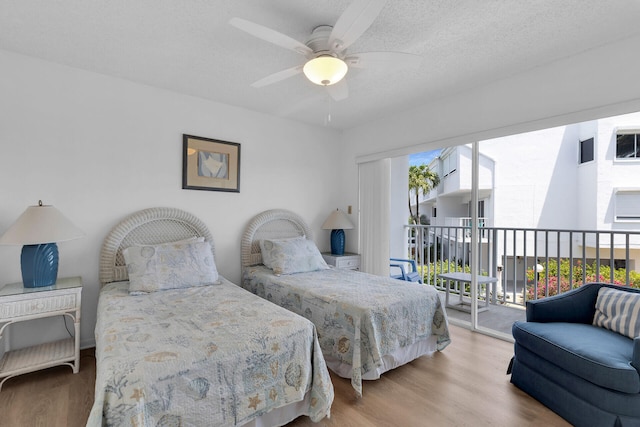 95 Coco Plum Dr Unit 2D, Marathon, FL 33050 - bedroom featuring access to exterior, wood finished floors, and ceiling fan