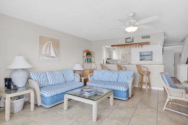 95 Coco Plum Dr Unit 2D, Marathon, FL 33050 - living room featuring ceiling fan, light tile patterned flooring, and a textured ceiling