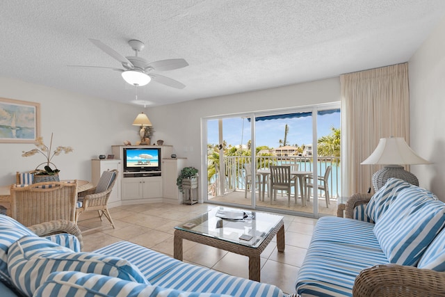 95 Coco Plum Dr Unit 2D, Marathon, FL 33050 - living area featuring light tile patterned flooring, ceiling fan, and a textured ceiling