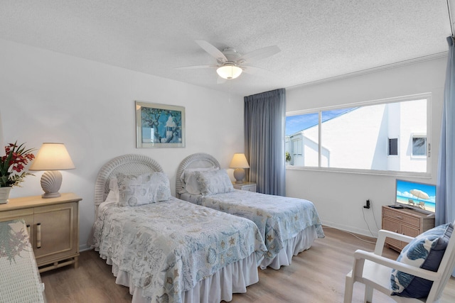 95 Coco Plum Dr Unit 2D, Marathon, FL 33050 - bedroom featuring light wood finished floors, a textured ceiling, and ceiling fan
