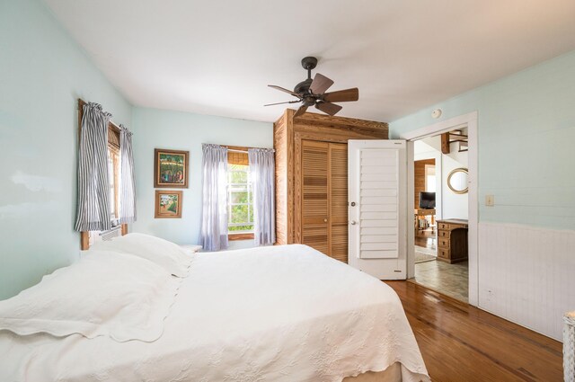 bedroom featuring hardwood / wood-style floors, a closet, and ceiling fan