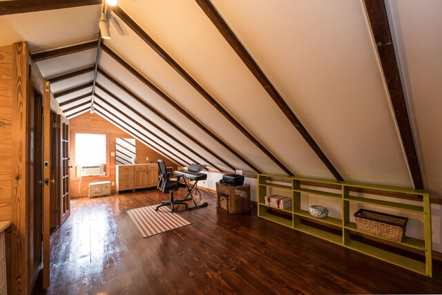 additional living space featuring hardwood / wood-style floors and lofted ceiling with beams