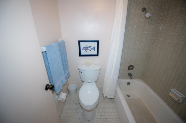 bathroom with tile patterned floors, toilet, and shower / bath combo with shower curtain