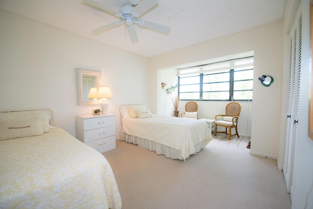 carpeted bedroom featuring a closet and ceiling fan