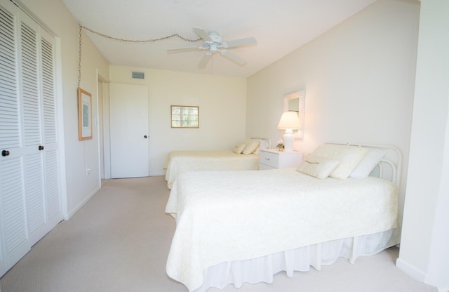 bedroom with light carpet, a closet, and ceiling fan