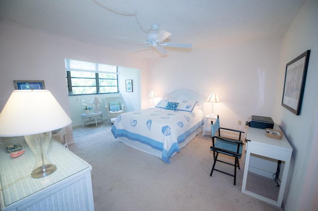 bedroom featuring light colored carpet and ceiling fan