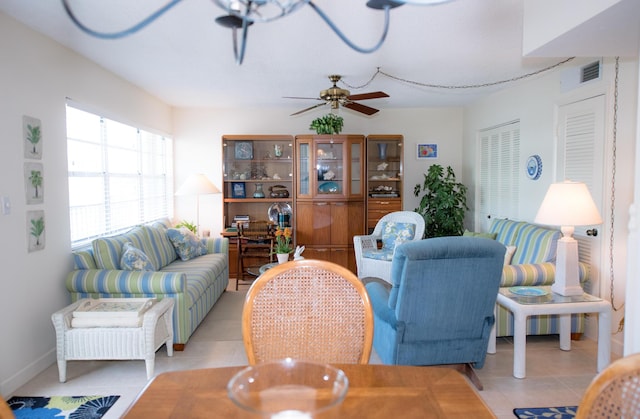 living room with light tile patterned flooring and ceiling fan