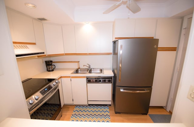 kitchen with sink, appliances with stainless steel finishes, white cabinetry, extractor fan, and ornamental molding