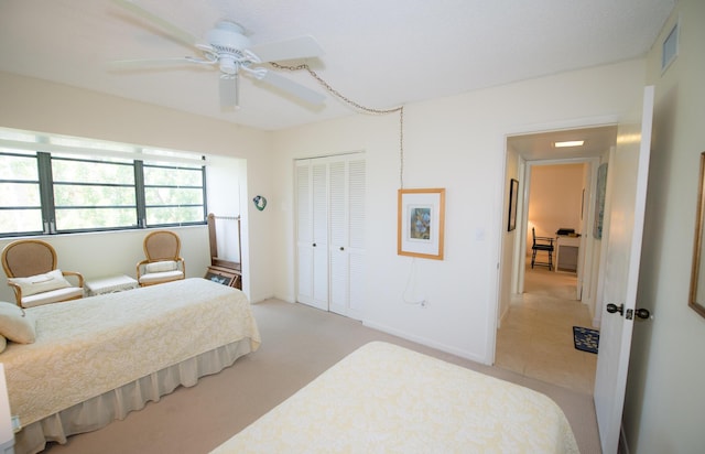 tiled bedroom with ceiling fan and a closet