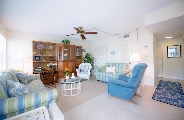 tiled living room featuring ceiling fan