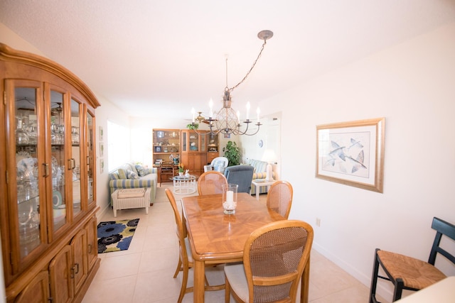 dining space featuring an inviting chandelier and light tile patterned floors