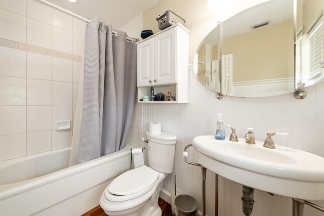 full bathroom with sink, toilet, and shower / bath combo with shower curtain