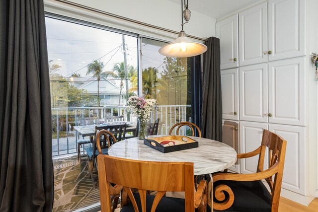 dining space with light hardwood / wood-style floors