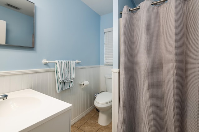 bathroom featuring tile patterned flooring, vanity, a shower with shower curtain, and toilet