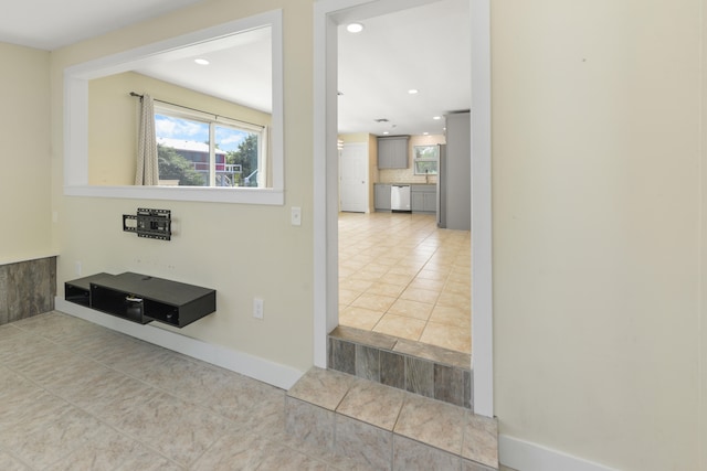 hall featuring light tile patterned flooring