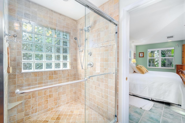 bathroom featuring ensuite bathroom, visible vents, tile patterned flooring, and a shower stall