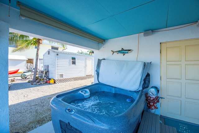 view of patio / terrace featuring an outdoor hot tub