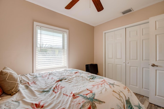 bedroom with ceiling fan and a closet