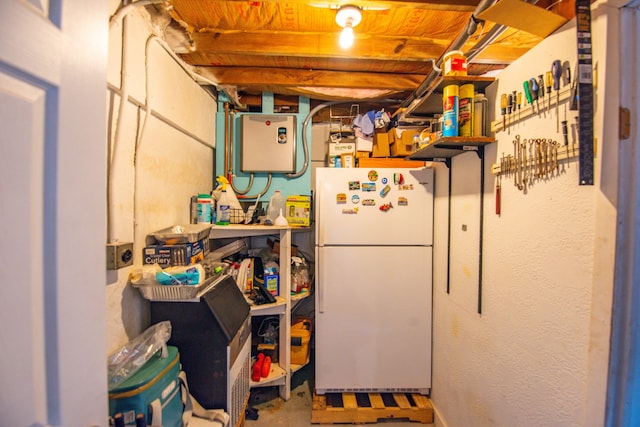 kitchen featuring white refrigerator and concrete floors