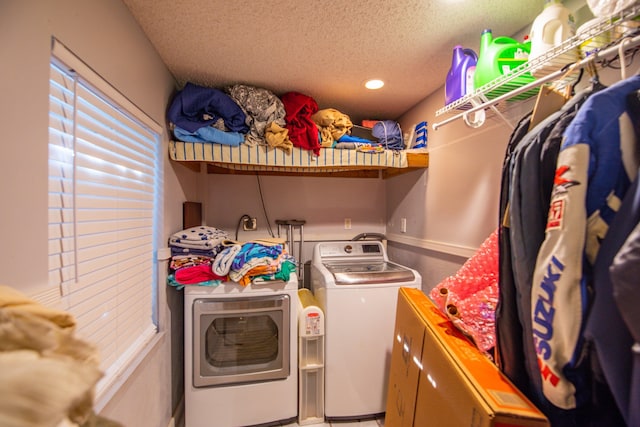 laundry area with a textured ceiling and independent washer and dryer