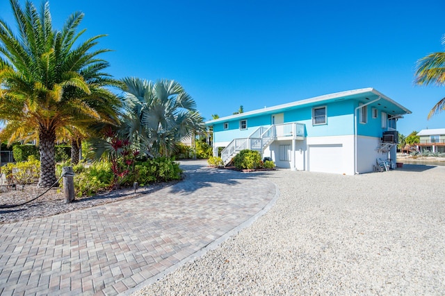 view of front of home featuring cooling unit and a garage