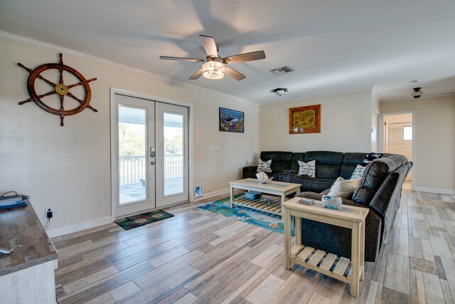 living room with crown molding, ceiling fan, light wood-type flooring, and french doors