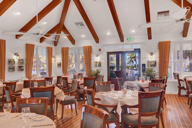2600 Overseas Hwy Unit 25, Marathon, FL 33050 - dining space with wood-type flooring, a ceiling fan, beamed ceiling, wooden walls, and high vaulted ceiling